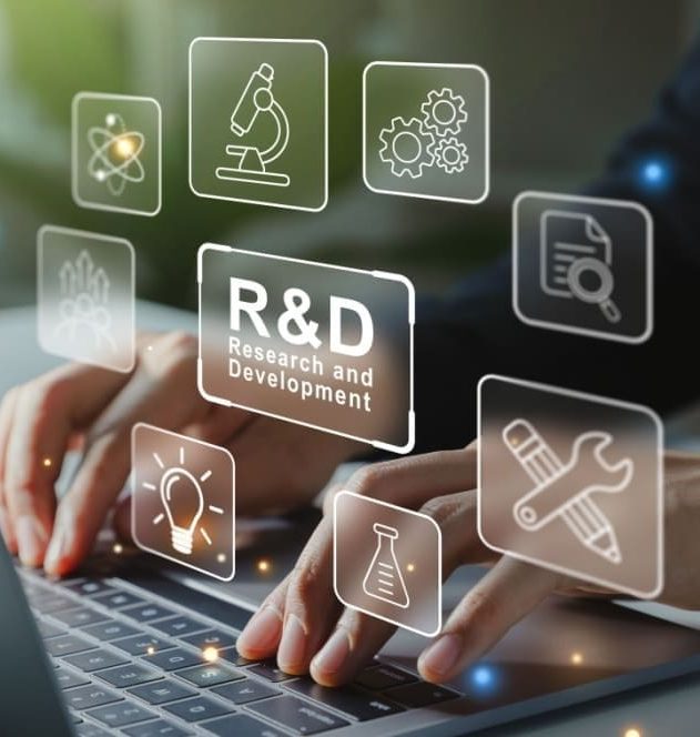 A person typing on a laptop, surrounded by various transparent icons related to research and development (R&D) floating above the laptop. The icons encircle a box with the text 'R&D', with 'Research and Development' written smaller underneath.