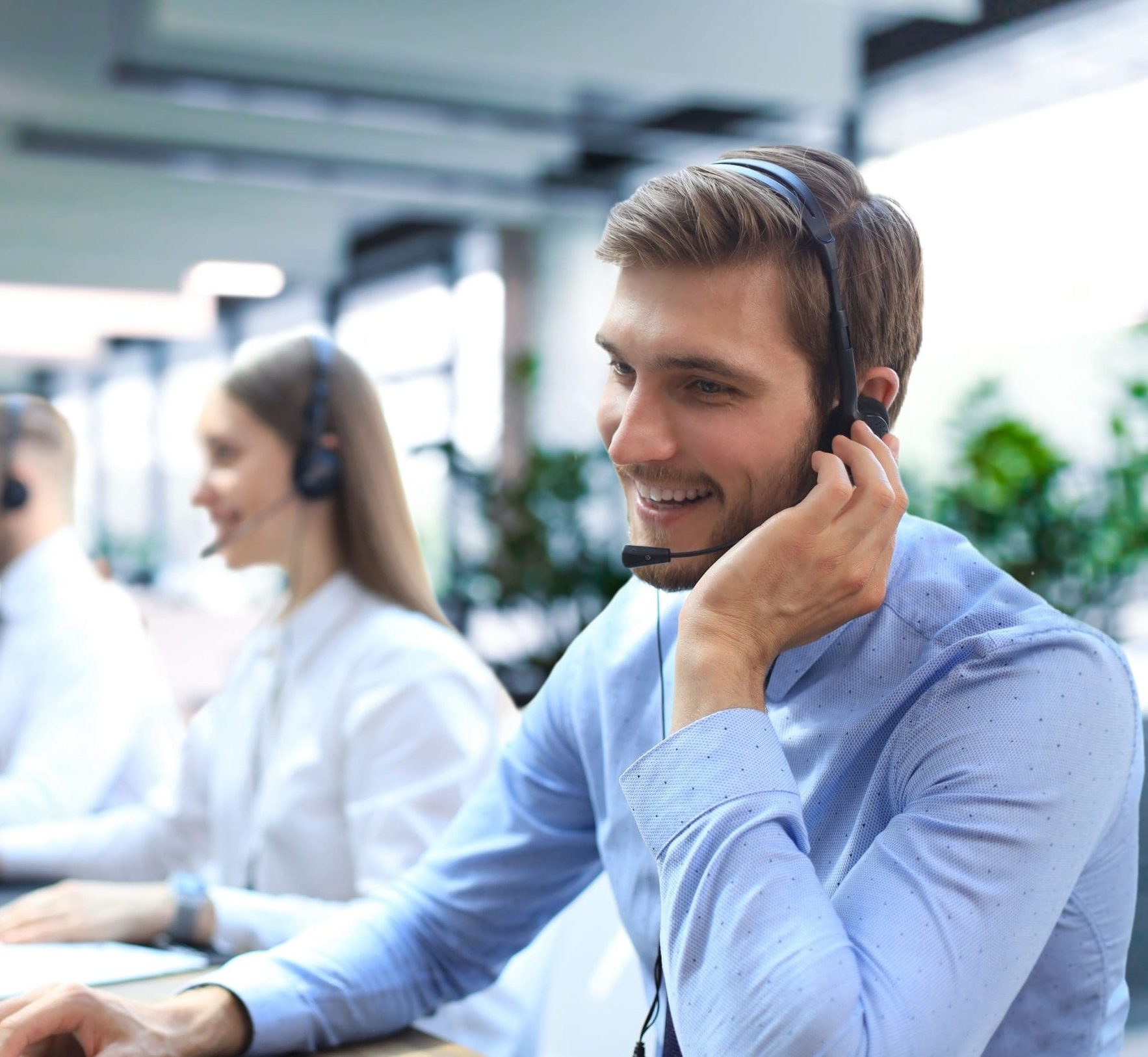 A friendly R&D professional wearing a headset and communicating with a client.