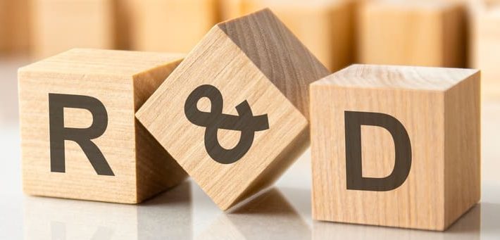 Three wooden cubes with the letters 'R&D' on.