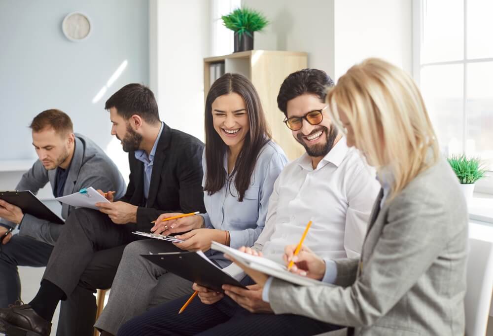 group of colleagues smiling during a business meeting