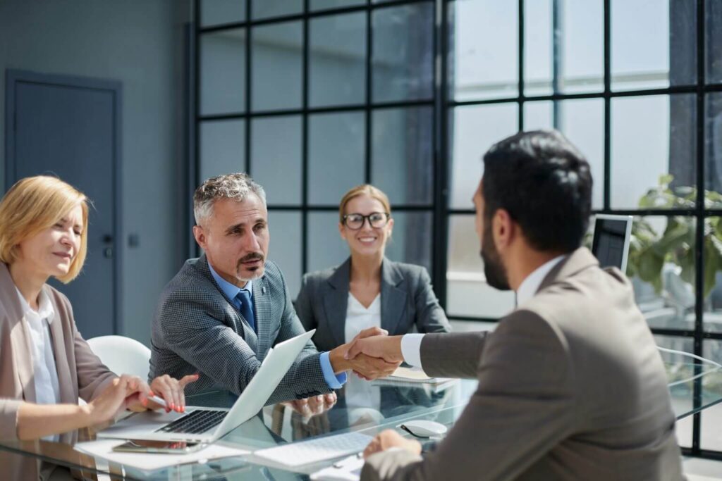 a mix of male and female colleagues working together in a meeting in a professional office environment