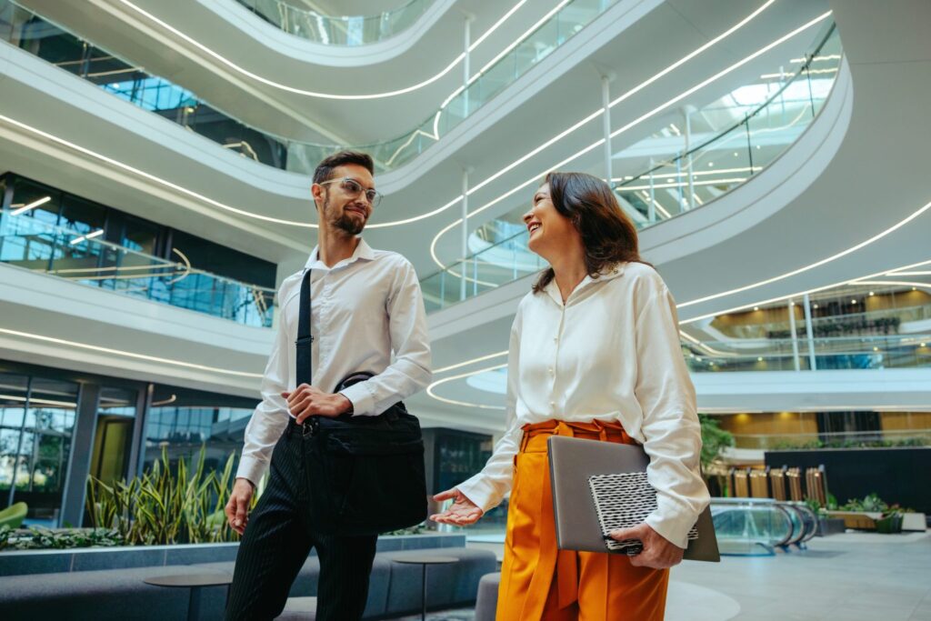 male and female tax relief colleagues walking in office