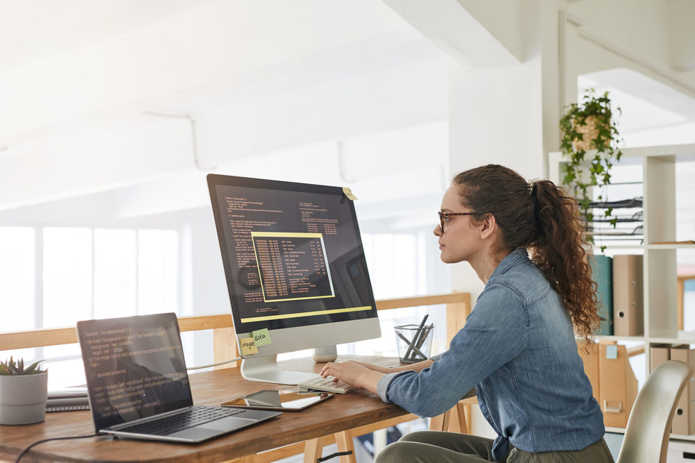 female software developer working at a desk